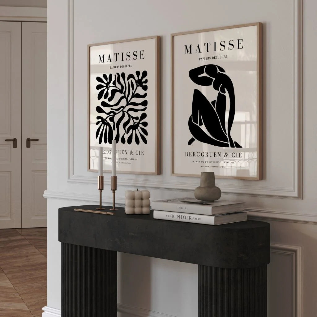 Set of 2 black abstract posters styled above sofa in modern living room wall decor