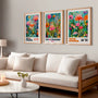 Pink, orange and turquoise floral poster set of 3 in living room, bright botanical wall decor above sofa