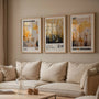 Gold botanical poster set of 3 in living room, elegant beige black wall decor above sofa